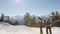 Man and woman with skis in hand to ski resort climb on foot to the top.