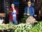 Man and woman sort green onions in store