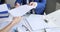 Man and woman sorting documents with hole punch and stapler and putting them in folder 4k movie