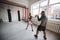 A man and a woman sparring partners train in the fighters training hall in boxing gloves with paws