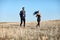 Man and woman in sportswear running in field