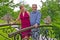 The man and the woman stand on the decorative bridge in the park