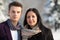 Man and woman stand in scarfs in the winter outdoors