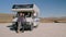 Man and woman standing by camper car while traveling in countryside on summer day rbbro.