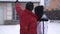 Man and woman standing in winter backyard. Man points up, girl hugs him close up. Happy couple have a fun. Concept of