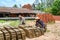 Man and woman staple handmade bricks near Mekong River, Vietnam