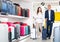 Man and woman with suitcases in shop selling bags and suitcases
