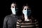 Man and woman with surgical masks. Couple protected with face mask. Pandemic or epidemic, scary, fear or danger concept.