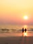 Man and woman sweet lover on the beach with sunset