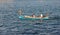 Man and woman swim in traditional maltese boat with severe captain and taking photo