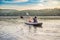 Man and woman swims on kayak in the sea on background of island. Kayaking concept.Kayaking concept with family of father