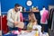 Man and woman tailors holding cardboard box at clothing factory