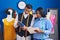 Man and woman tailors using touchpad looking notebook at sewing studio