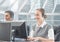 Man and woman talking on headset in customer service office