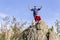 Man and woman tourists stand on the top of the mountain against the background of the Ural mountains