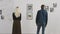 A man and a woman visited a modern art gallery. Visitors to the exhibition watch abstract paintings collages.