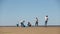 Man and woman volunteers with family recycle plastic bottle child boy collect plastic and polyethylene trash on beach