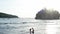 Man and Woman Walking Along Tropical Beach at Sunset, Tracking aerial shot of young couple on vacation having fun on the