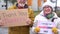 A man and a woman in warm clothes hold signs with the inscriptions thank you truckers and freedom convoy. Outdoor