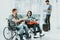 Man and Woman in Wheelchairs in Airport Lounge.