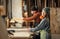 Man and woman working in carpentry workshop