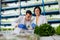 Man and woman working in greenhouse analyzing seeds