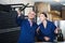 man and women coworkers looking at bubbly wine in bottle standing in wine cellar