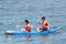 Man and women kayaking down a sea