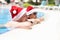 A man and women in santaclaus hats are resting in the pool