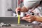 Man work in home workshop garage measure metal with tape meter and use pencil, on the workbench with wrenches and hammer, diy and