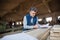 A man worker in the carpentry workshop, making plans.