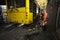 Man worker conducting technical inspection for trolleybus parked at the trolley depot hangar, depot maintenance. Kiev