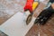 Man worker cutting beige tile with a saw on a cutting flooring tile