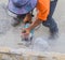 Man worker cutting concrete with Circular saw.
