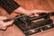 Man worker cutting a piece of metal with a iron saw, on the iron vise locked, hands only. extreme closeup.