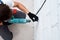 Man worker drilling wall with hammer drill, top view