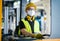 Man worker forklift driver with protective mask working in industrial factory or warehouse.