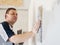 Man worker putting plaster on the wall