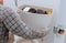 Man worker repairing with toilet tank in bathroom, closeup