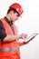 Man worker in safety vest hard hat using tablet