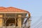 Man worker on scaffold painting roof