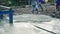 Man worker using a concrete steel basket for cement after Pouring ready-mixed concrete