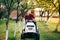 Man worker using lawnmower and cutting garden grass. Backyard maintanance works