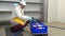 Man worker washes and disinfects red brushes in industrial workshop.