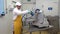 Man worker washes of slicer for sausage and cheese in industrial workshop.