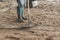 Man workers spreading freshly poured concrete mix