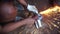 Man working with circular saw. Hot metal sparks