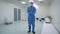 A man working in a clean room, pharmaceutical enterprise. Specialist in a protective suit, gloves, glasses and a mask.