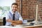 Man Working At Computer In Contemporary Office