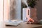 Man working on computer, using pc mouse near the aroma oil diffuser on the table, steam from the air humidifier, selective focus.